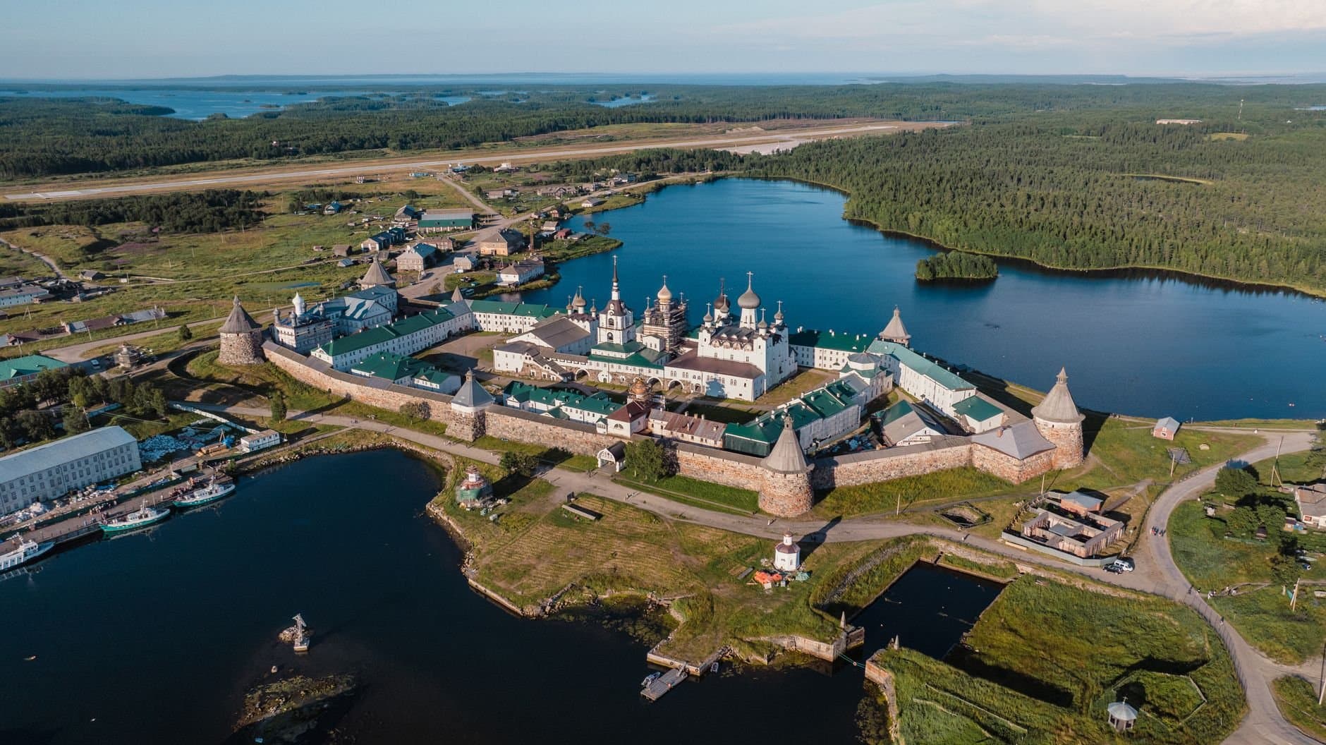 A breathtaking aerial view of Solovetsky Monastery surrounded by serene lakes and lush forests in Russia.