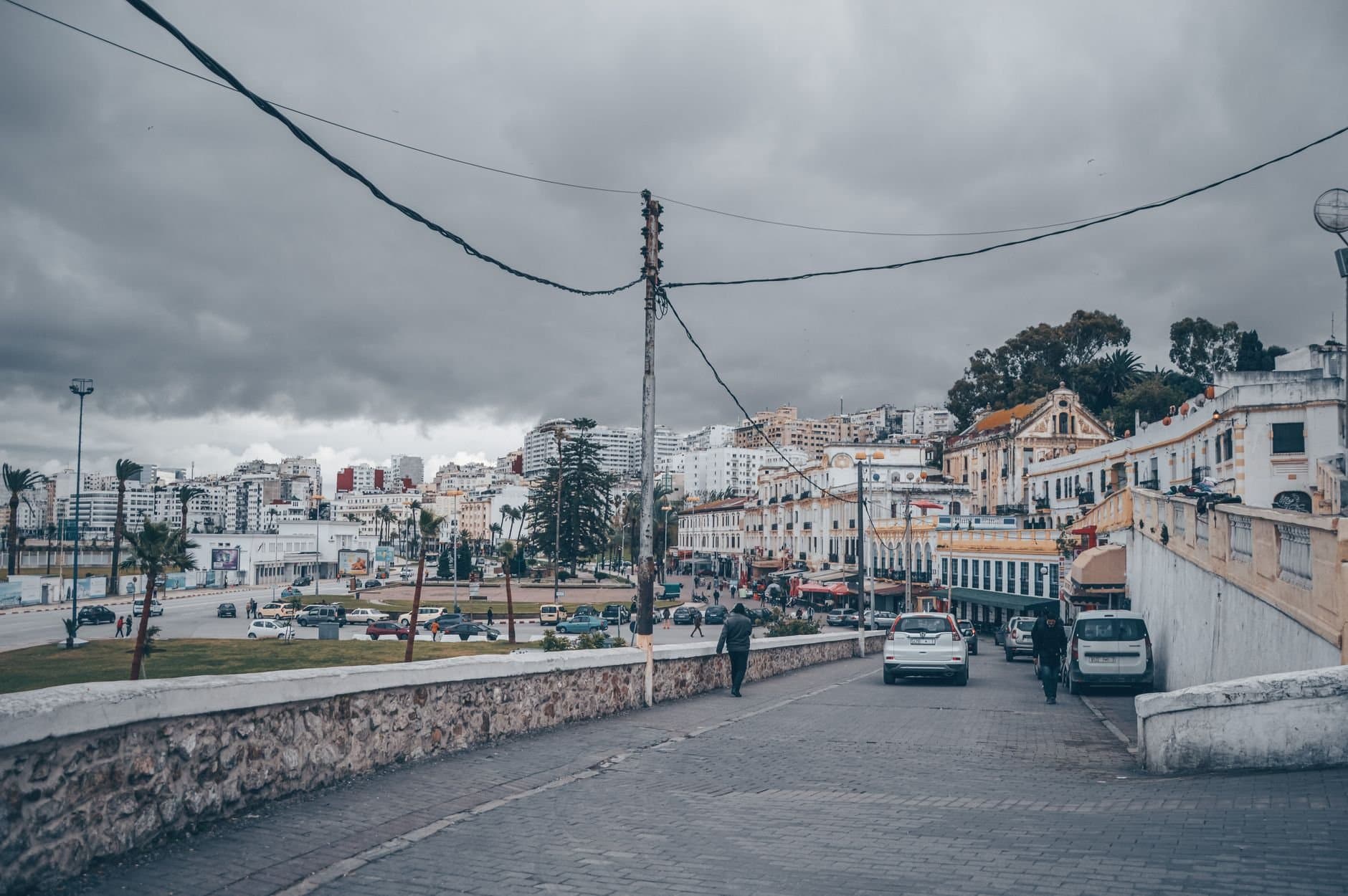 Overcast day in Tangier, Morocco, showcasing urban buildings and street life.