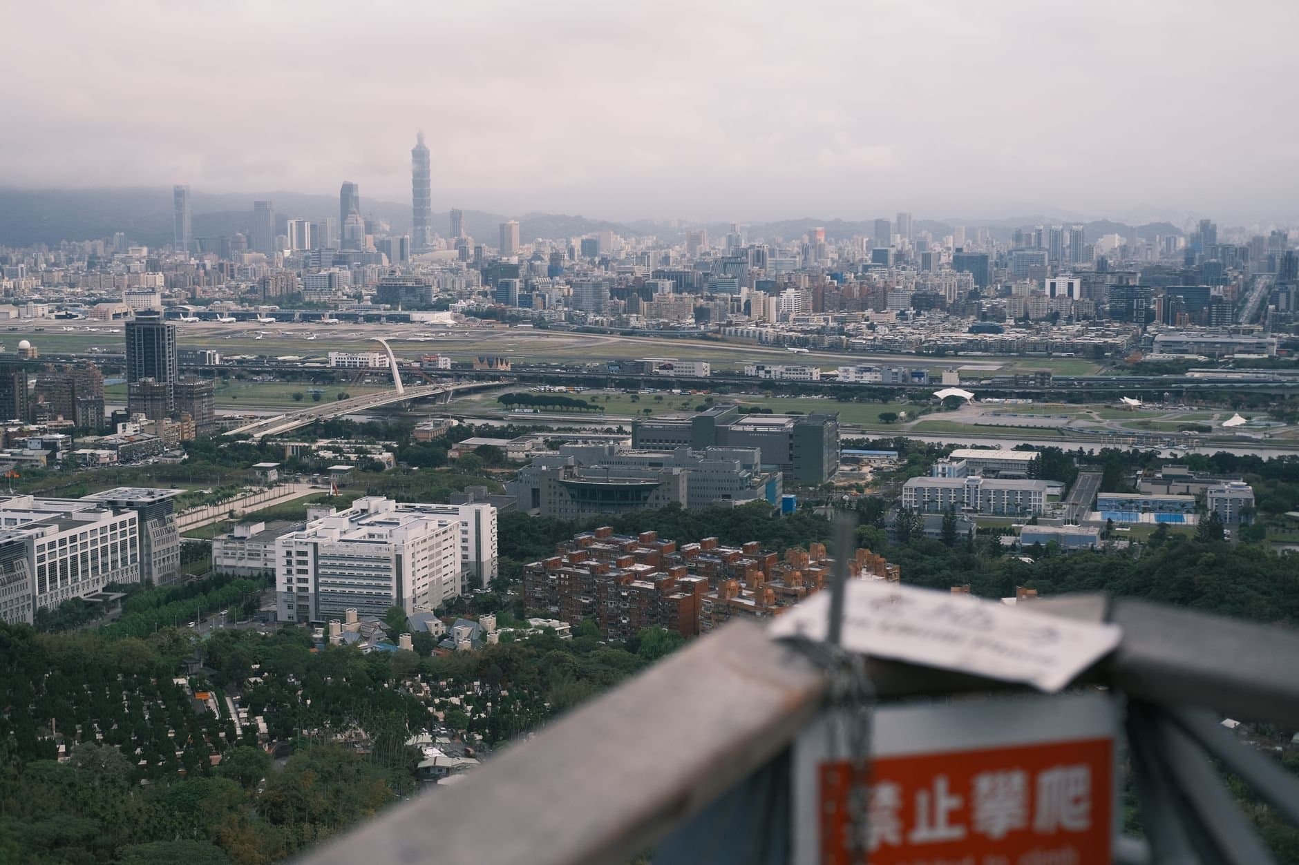 Aerial view of Taipei's sprawling cityscape featuring the iconic Taipei 101 skyscraper.