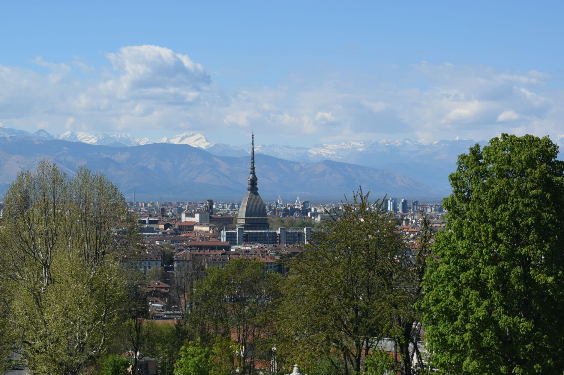 Turin cityscape with Mole Antonelliana and Alps under blue skies, Piemonte, Italy.