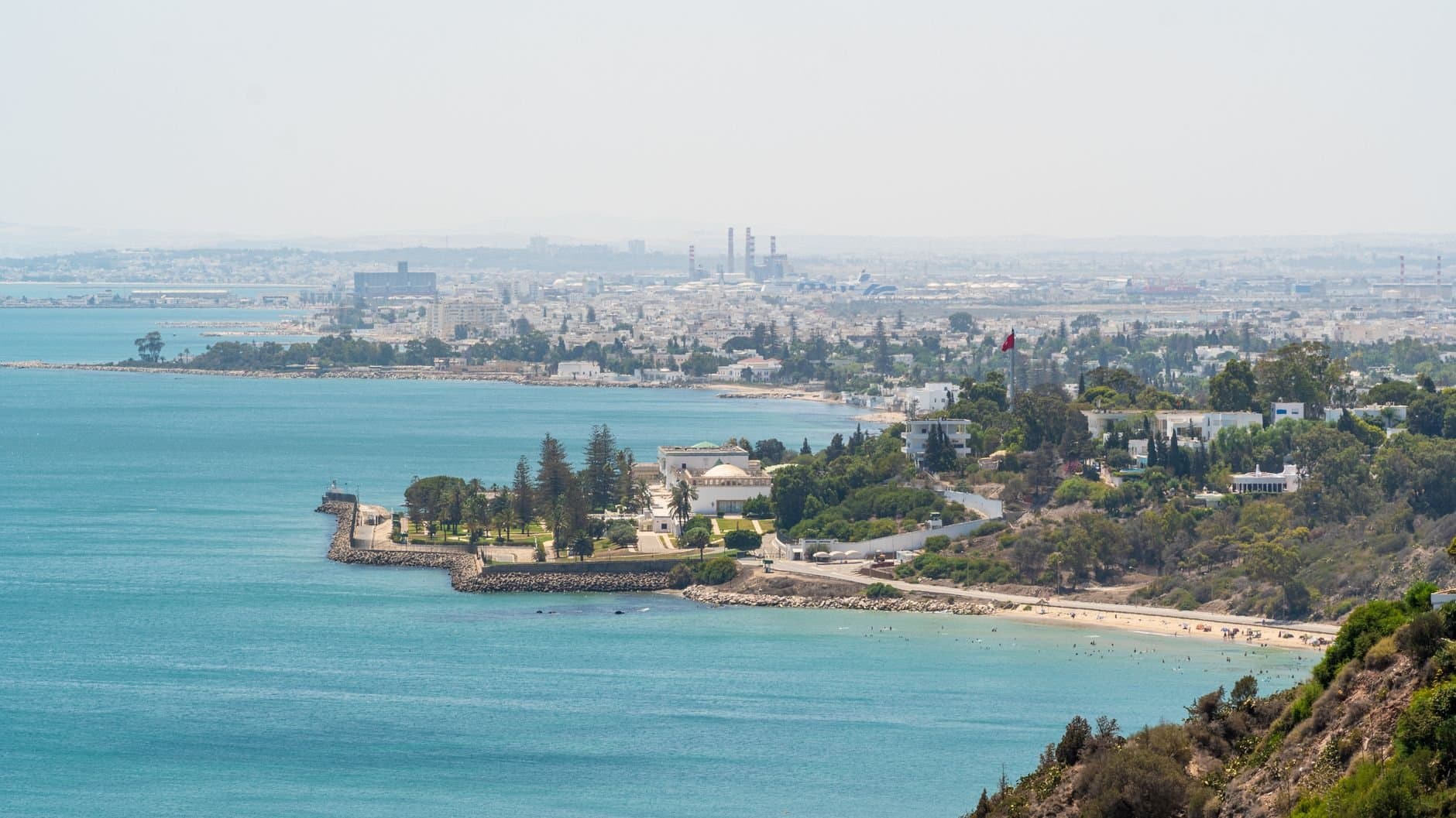 Aerial view of Carthage coastline in Tunisia, showcasing the blue Mediterranean Sea and lush greenery.