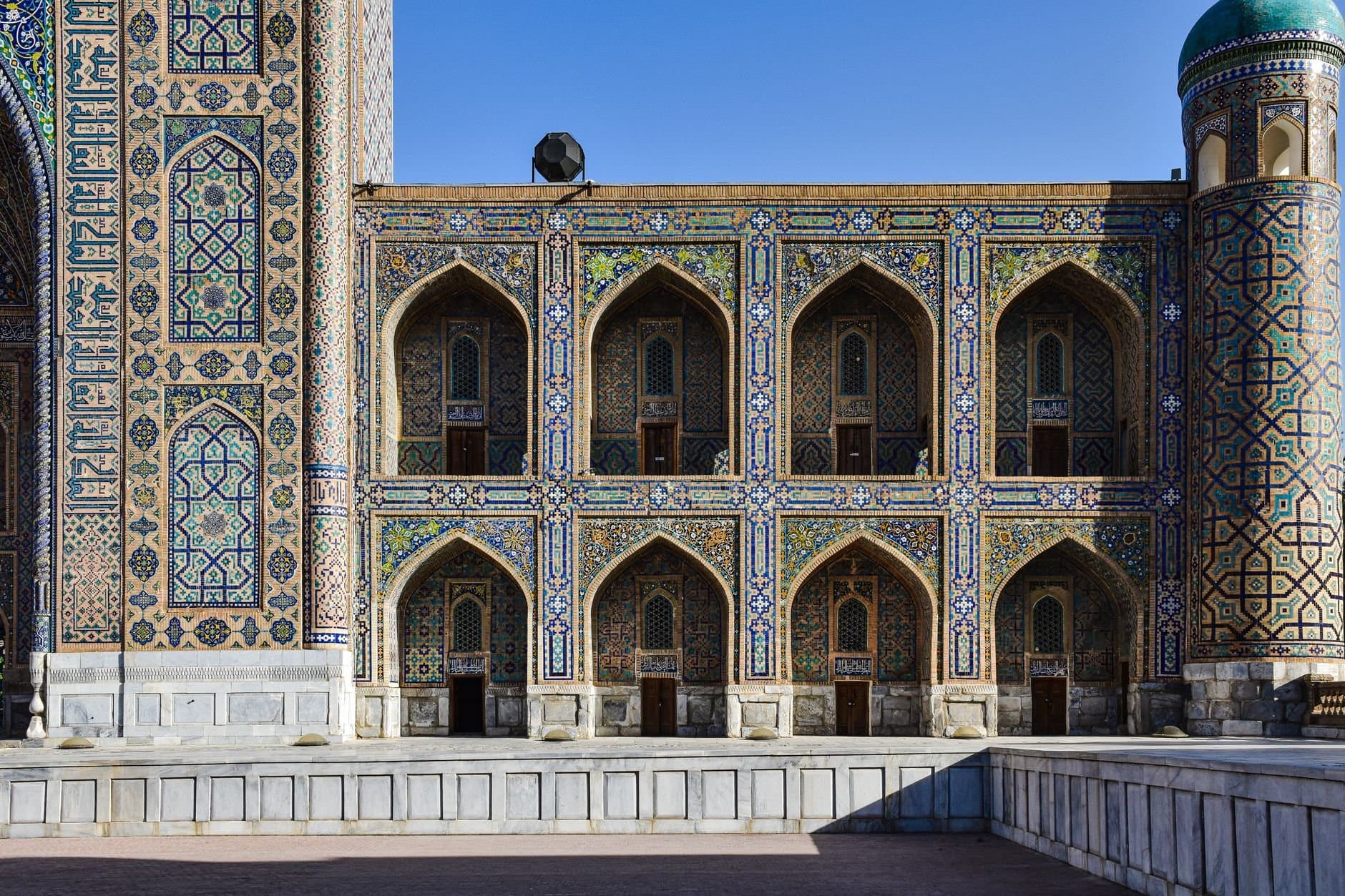 View of a beautifully ornate and traditional madrasa facade in Tashkent, showcasing intricate tile work.