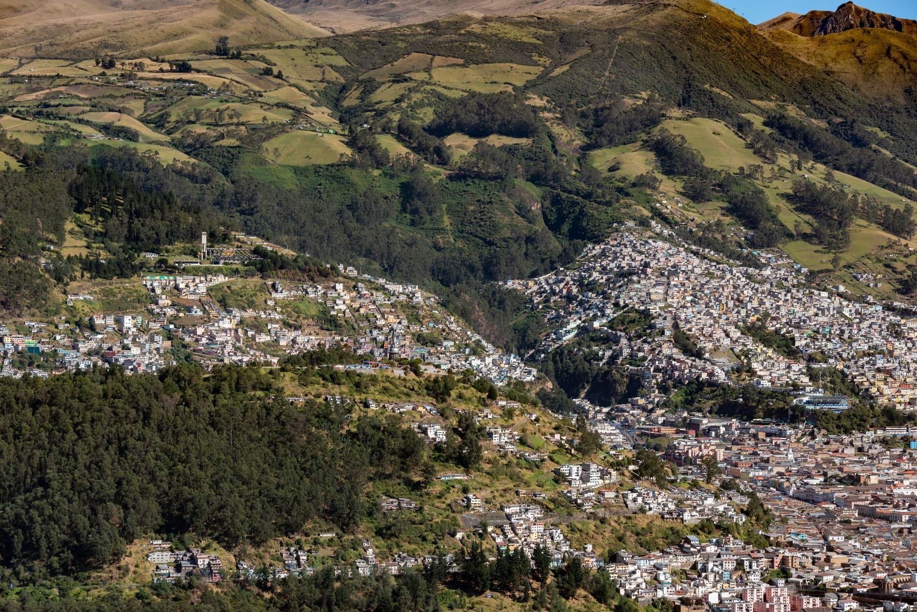 A stunning aerial view of the hillside towns and lush greenery in Quito, Ecuador.