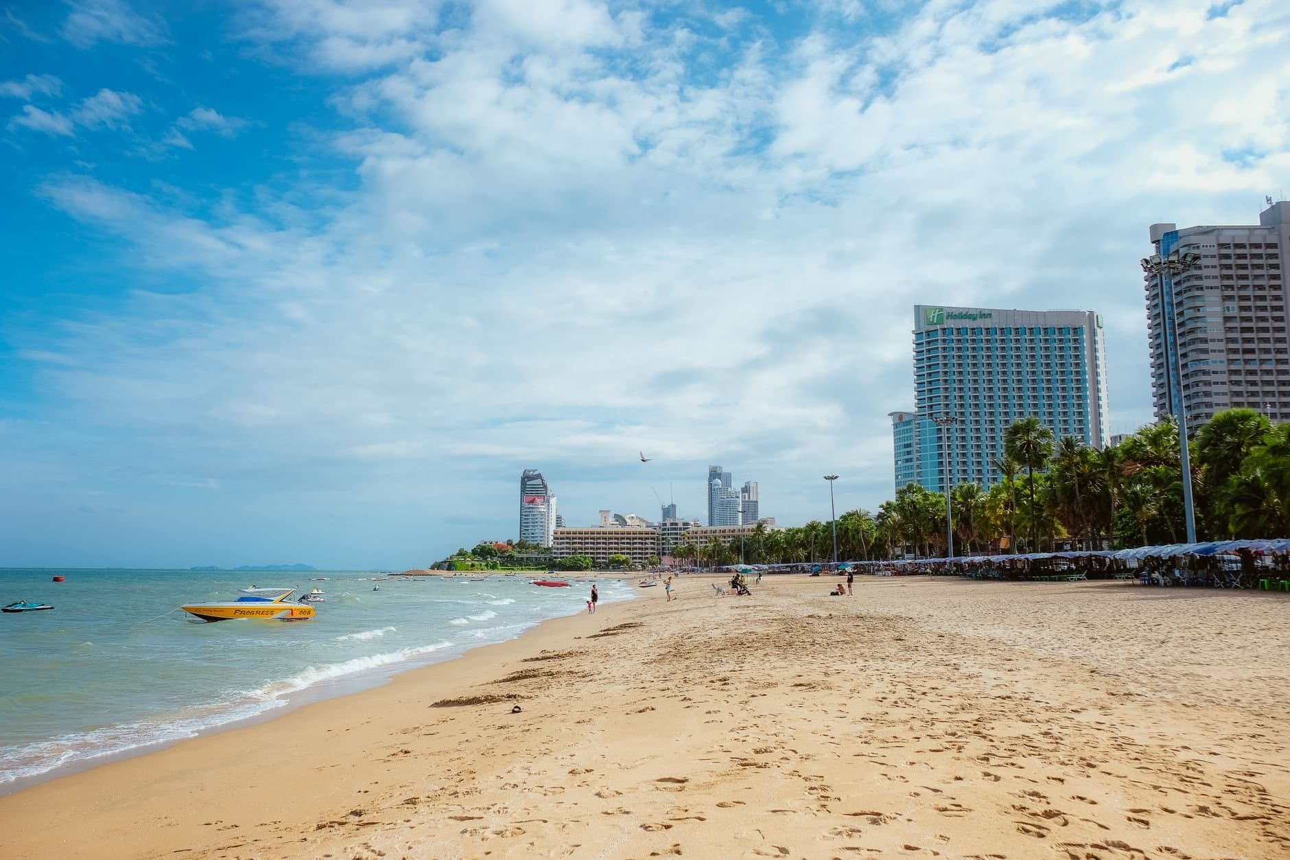 Vibrant city skyline meets tropical beach for the perfect vacation scene.
