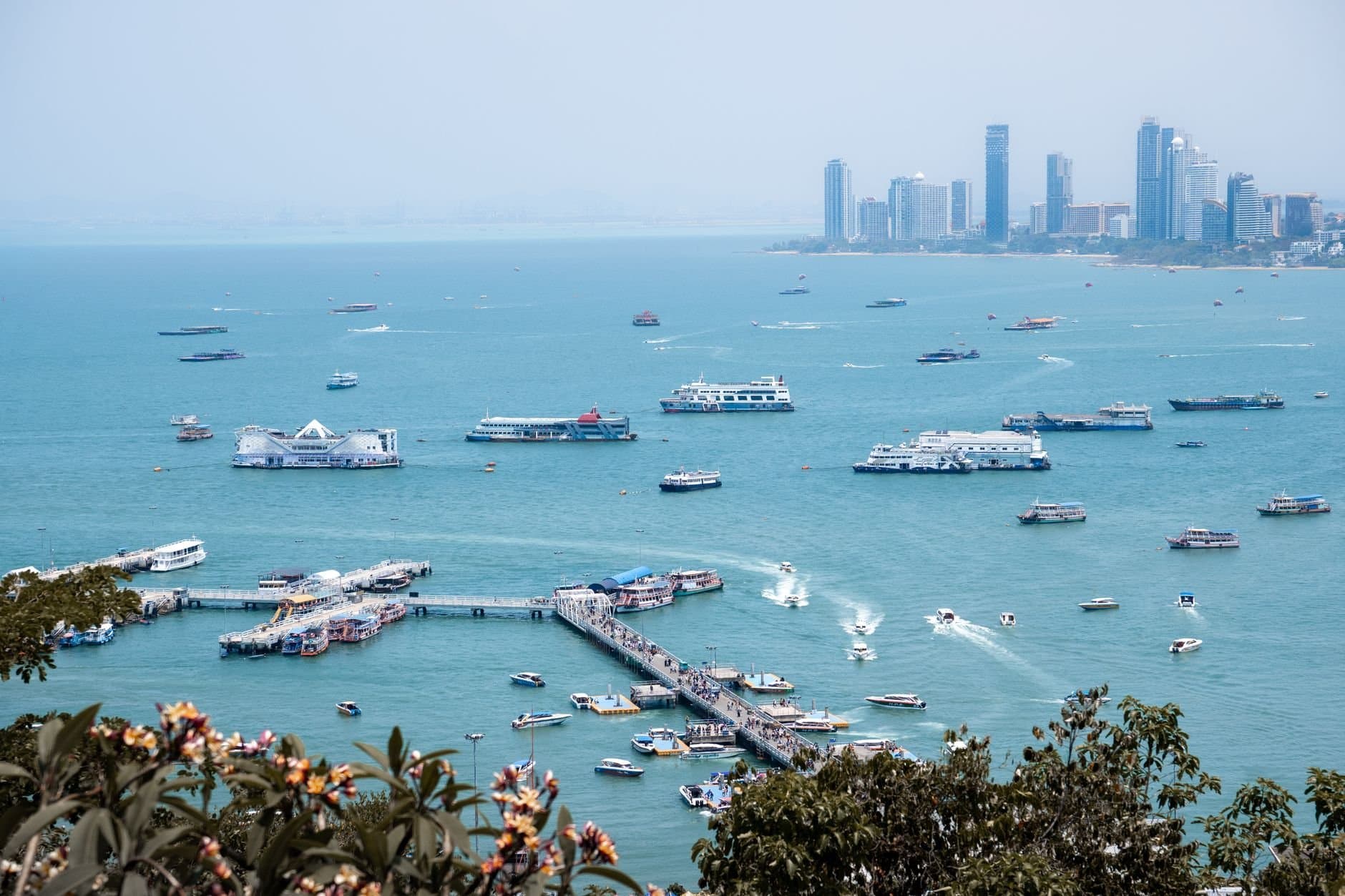 A vibrant harbor scene with boats in Pattaya City, Thailand.