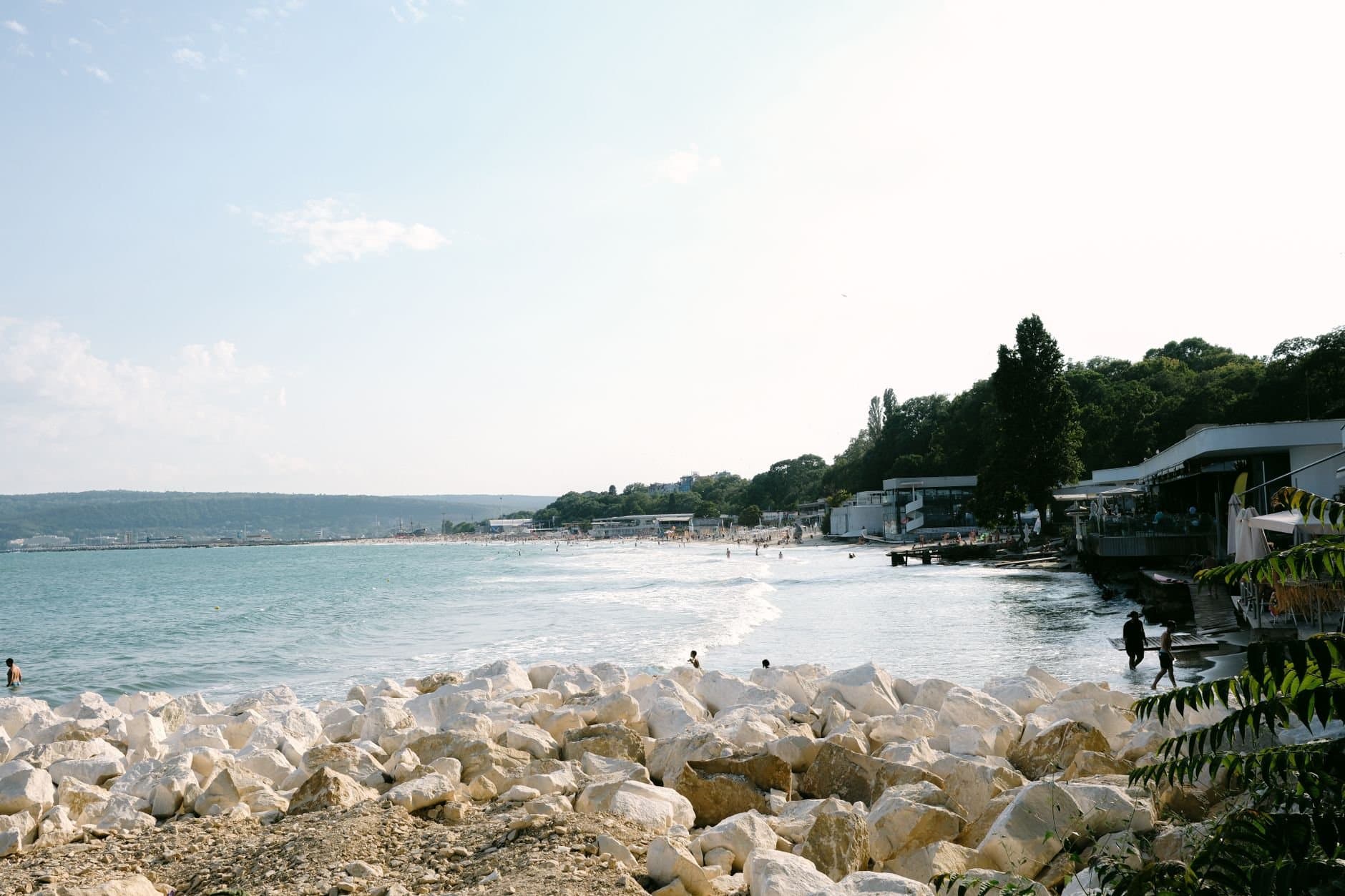 A tranquil beach scene in Bulgaria with clear blue waters and rocky shoreline. Perfect summer travel destination.