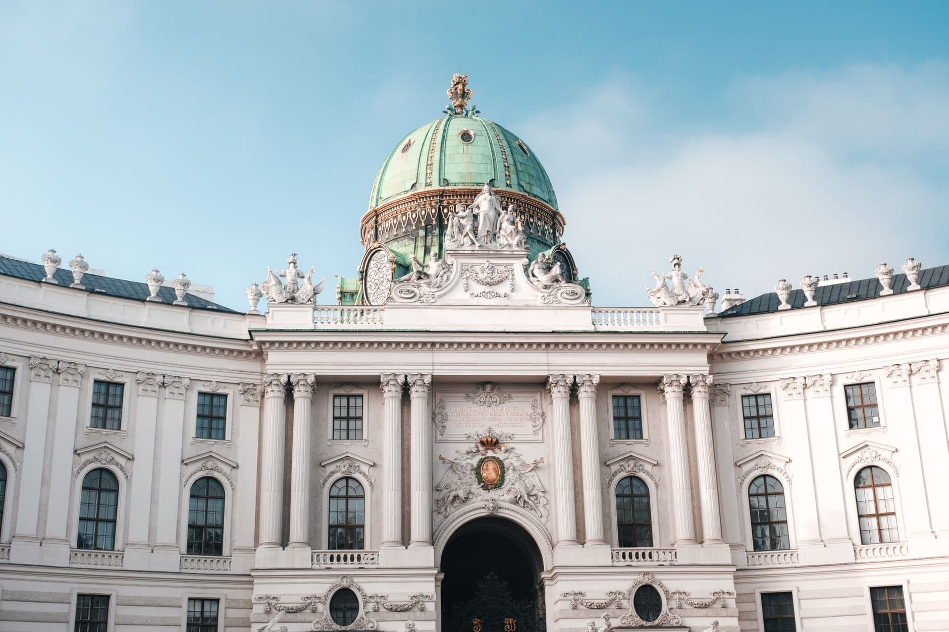 Elegant view of the Hofburg Palace's dome and facade in Vienna, Austria under a clear sky.