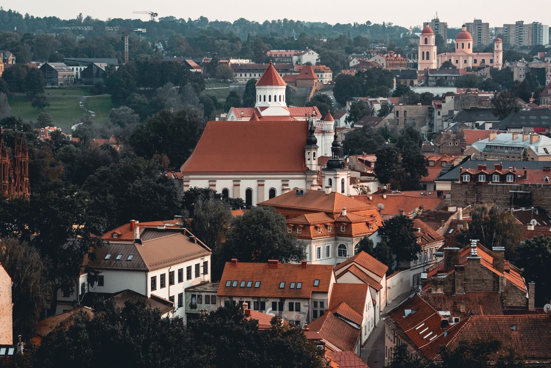 Charming aerial view of Vilnius old town with red-roofed buildings and historic architecture.
