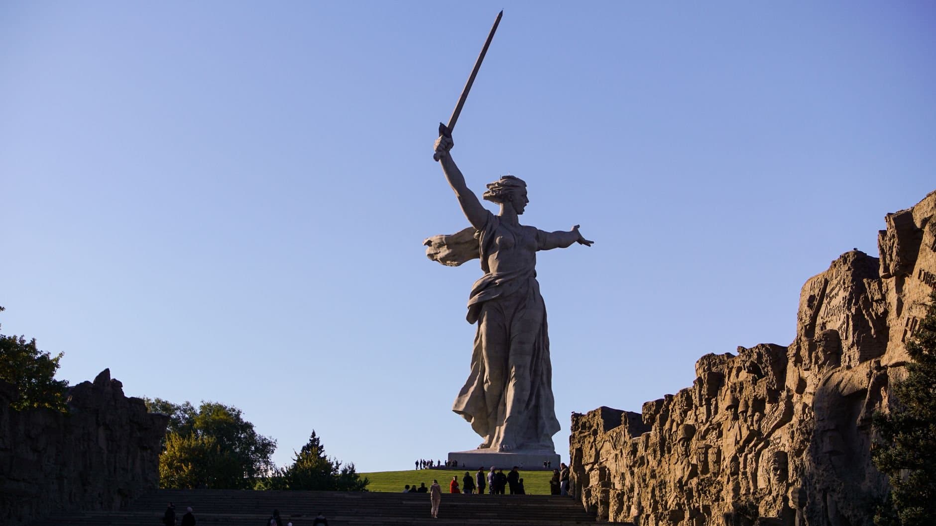 Statue of the Motherland Calls with sword under a clear sky in Russia.