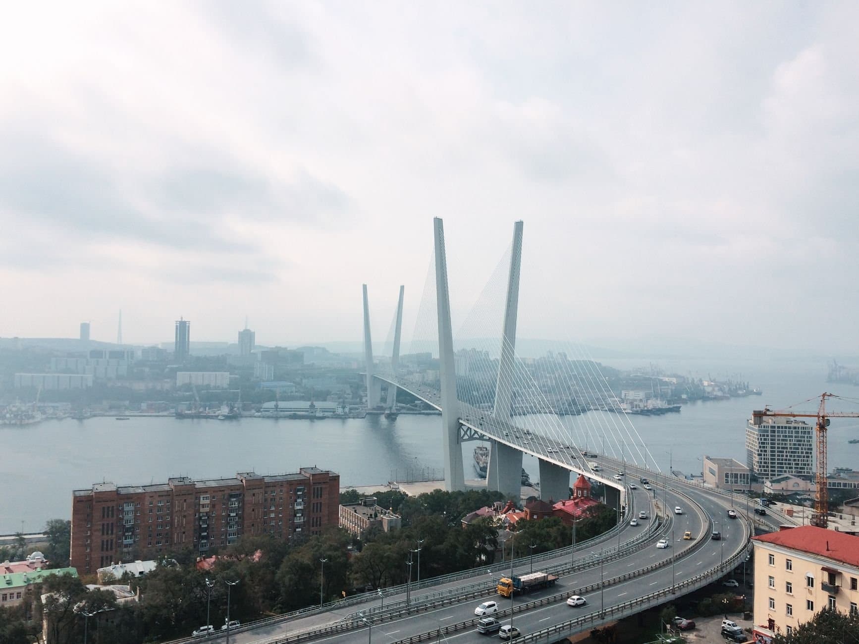 A scenic aerial view of the iconic Zolotoy Bridge in Vladivostok, Russia.