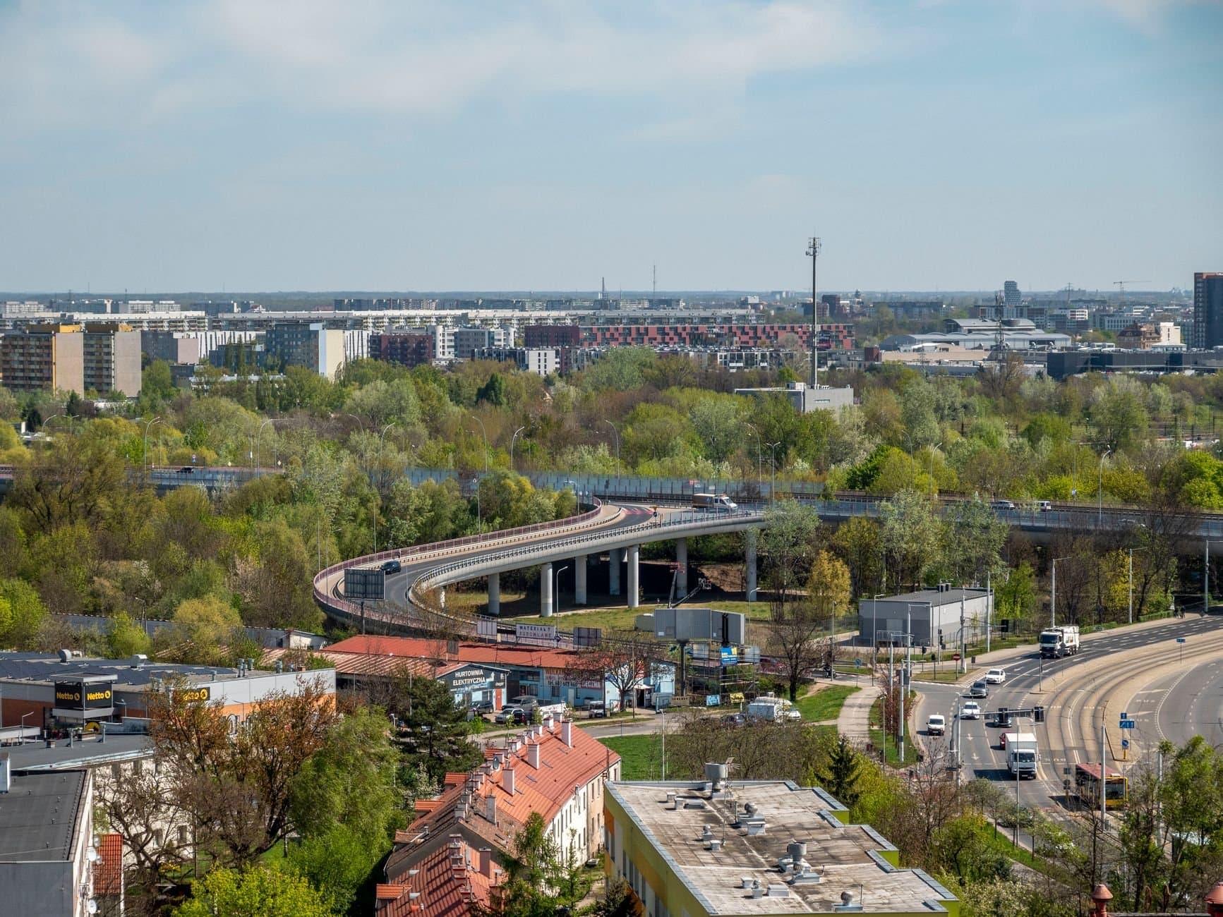 A scenic aerial view of Wrocław with winding roads and lush greenery in Poland.