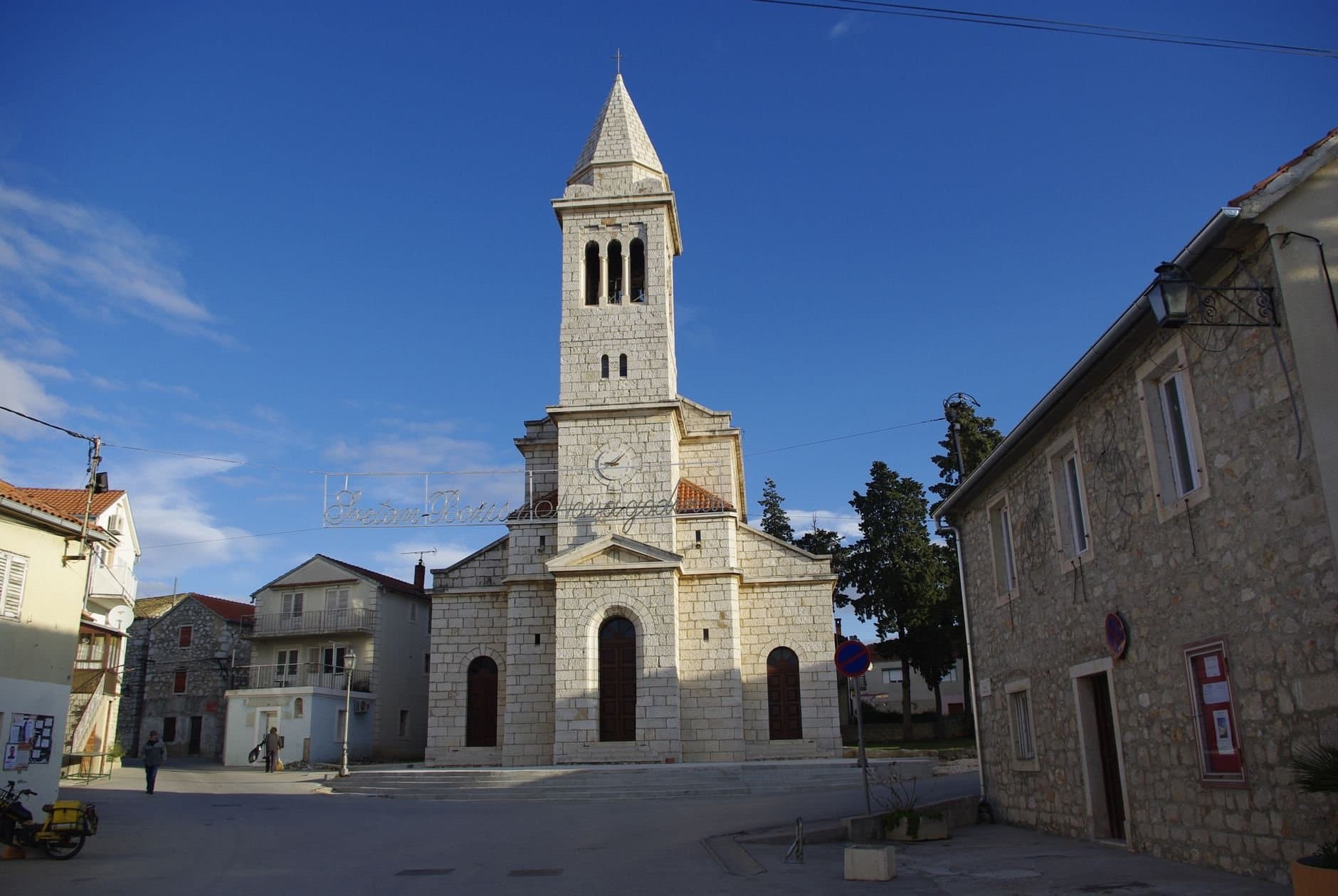 Beautiful stone church under a blue sky in Pakoštane, Croatia.