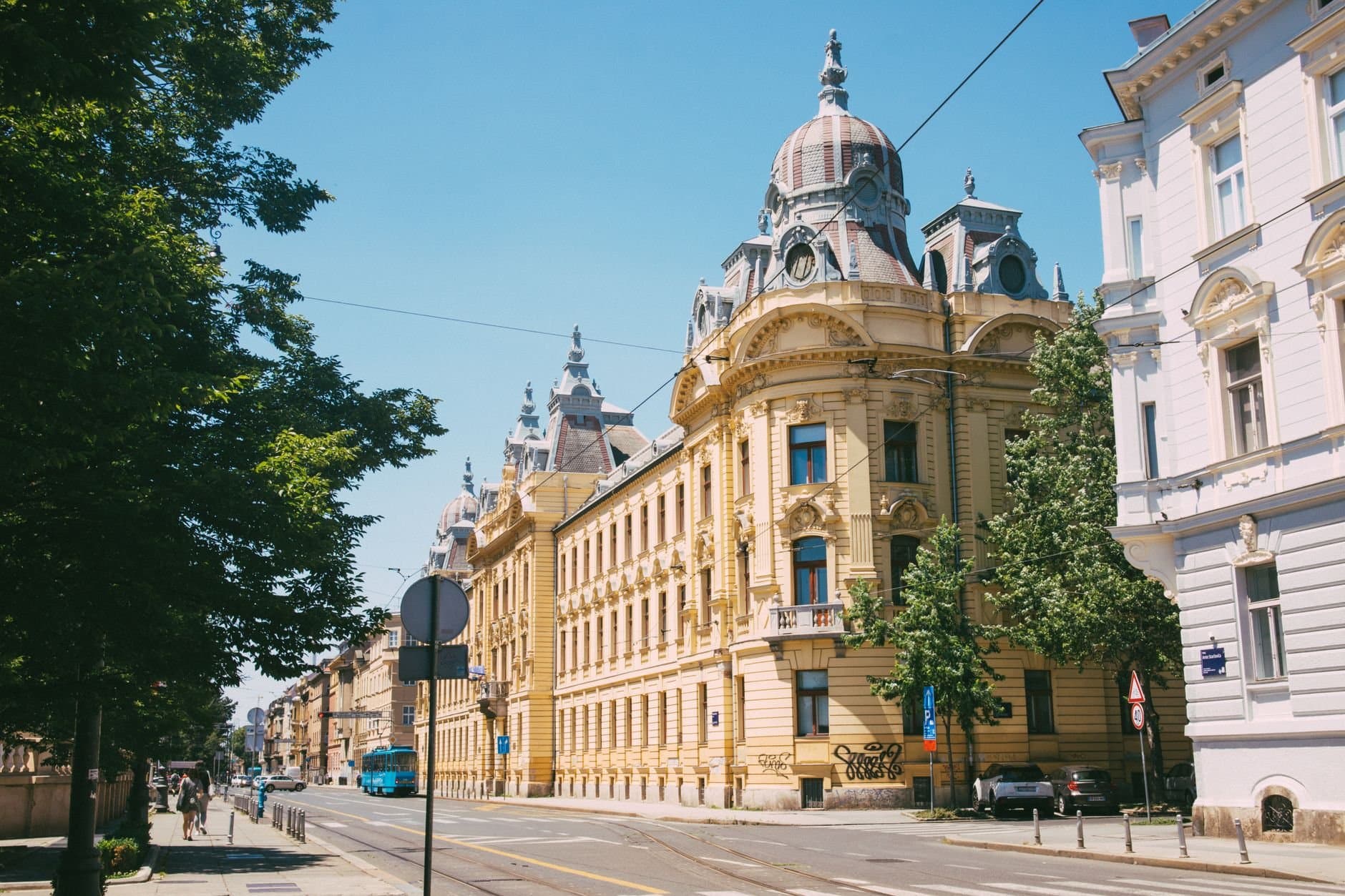 A picturesque street view in Zagreb showcasing historic architecture under clear skies.
