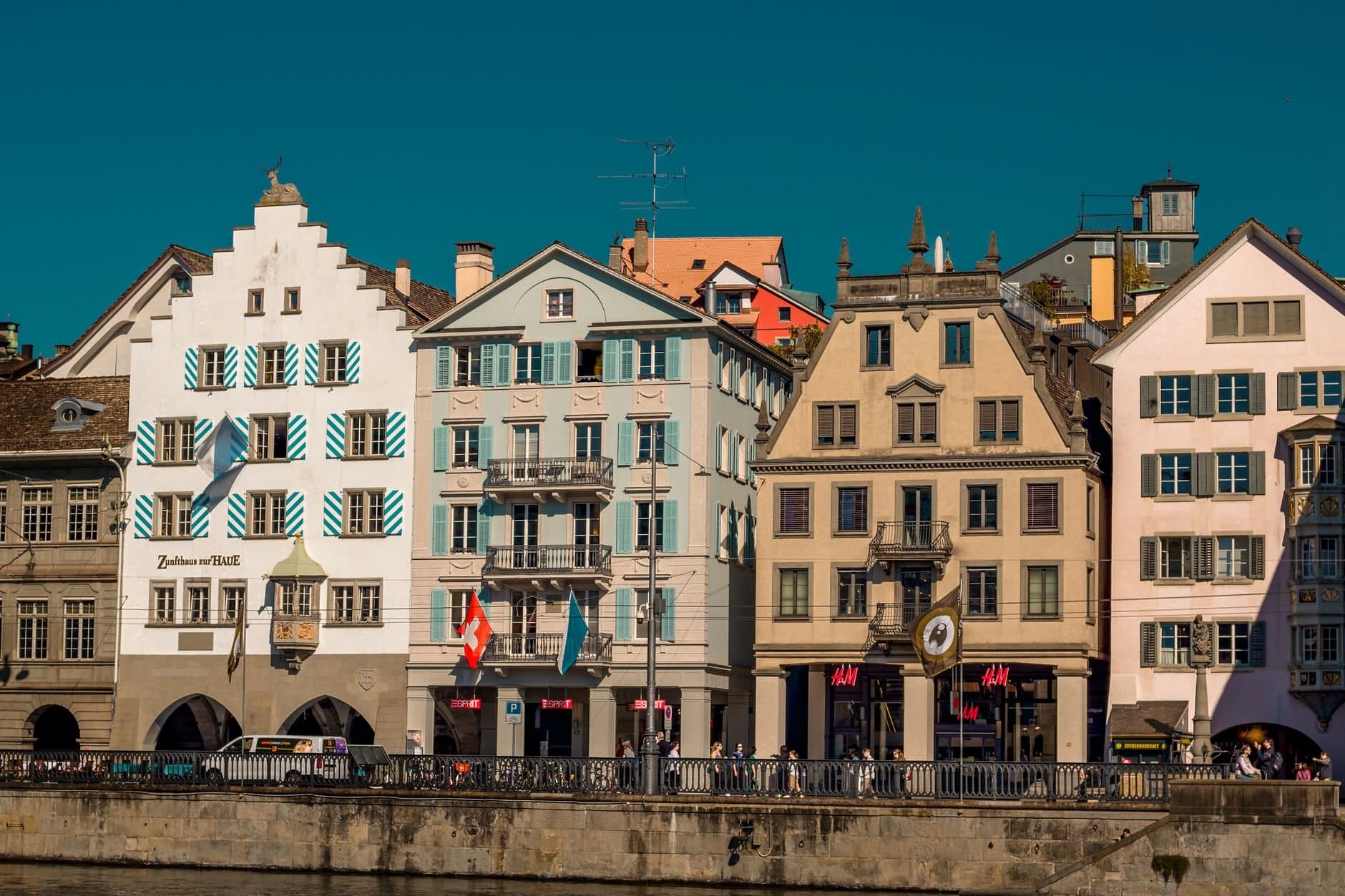 Elegant townhouses in Zurich's old town on a sunny day, showcasing Swiss architecture.
