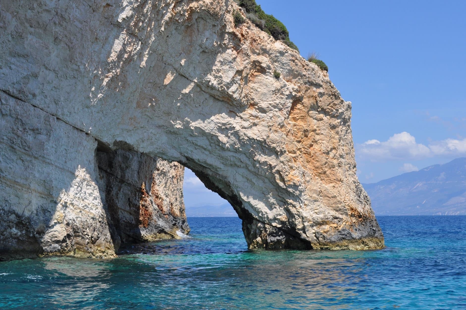 Explore the stunning rocky arch formation along the coast of Zakinthos, Greece.