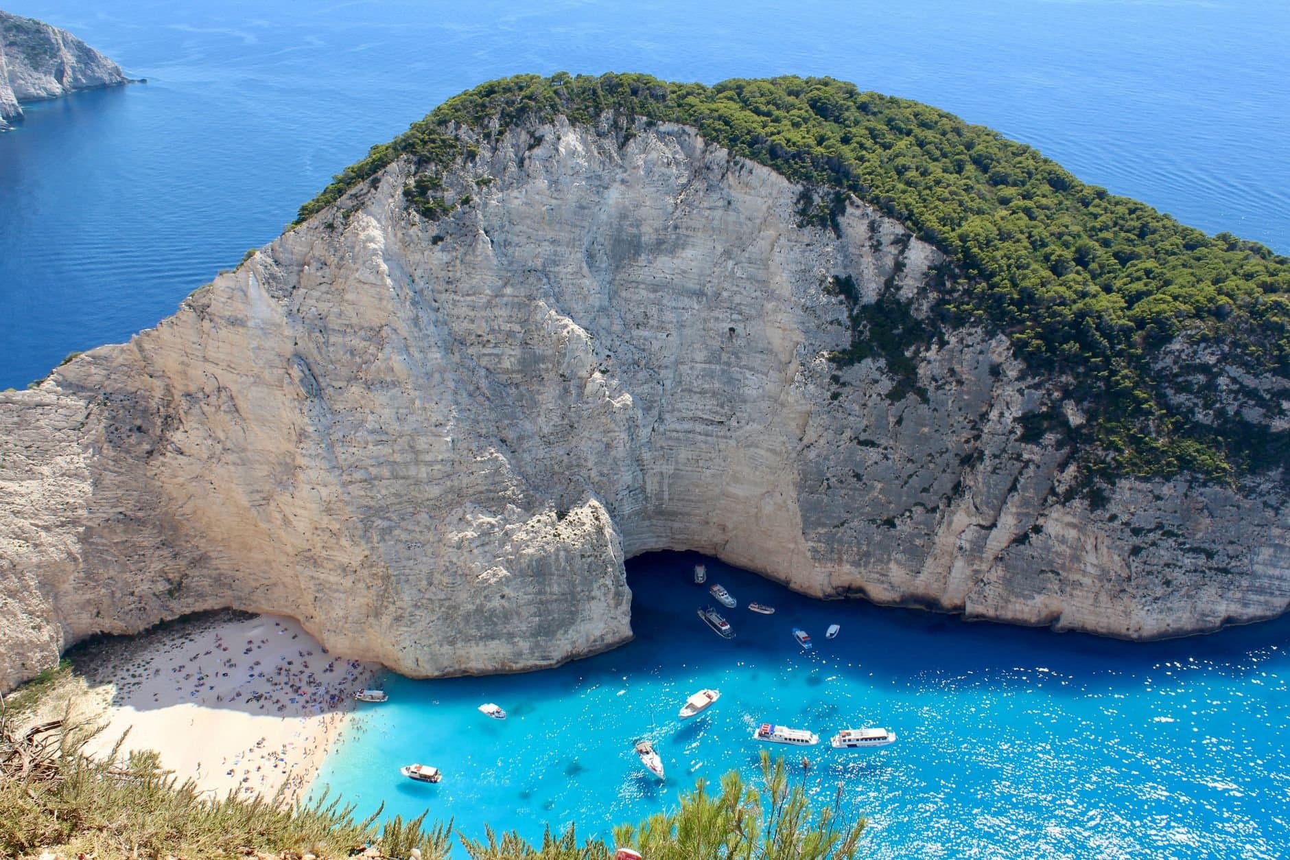 Stunning aerial view of Navagio Beach with turquoise waters and white cliffs in Zakinthos, Greece.