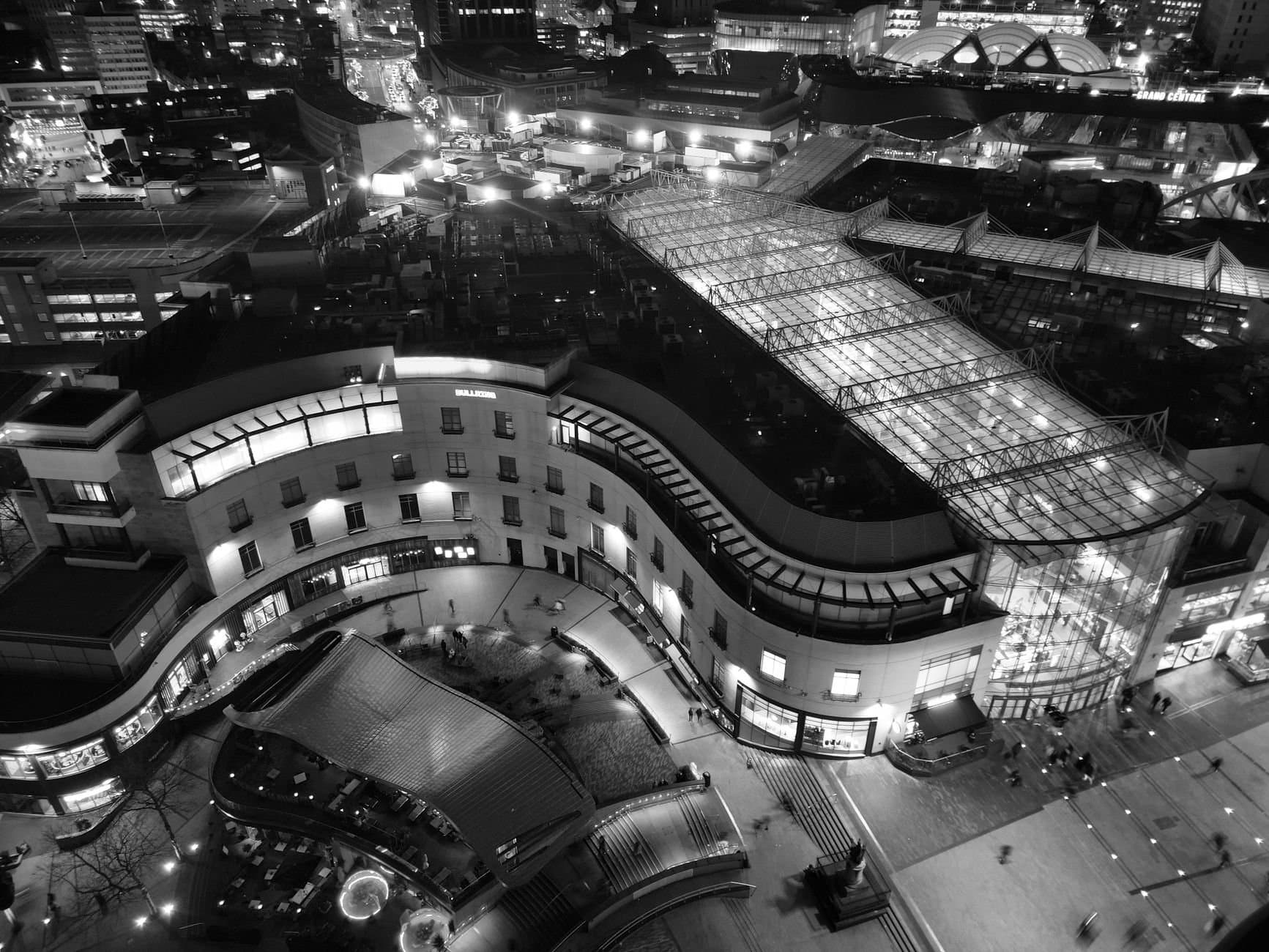 Striking aerial photograph capturing Birmingham's urban architecture at night in monochrome.