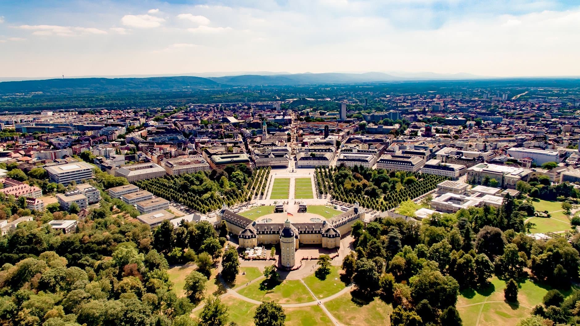 Aerial view showcasing Karlsruhe Palace and the surrounding cityscape with lush greenery.