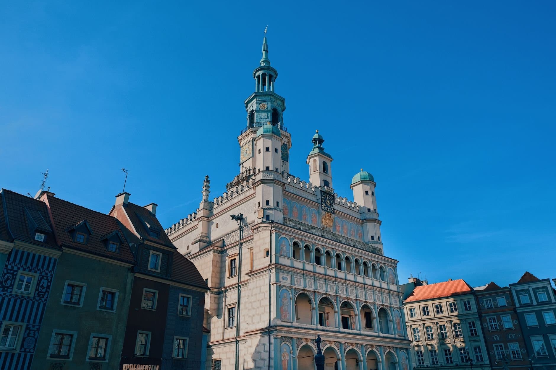 Low-angle view of Poznań Town Hall against a clear blue sky. Iconic renaissance architecture.