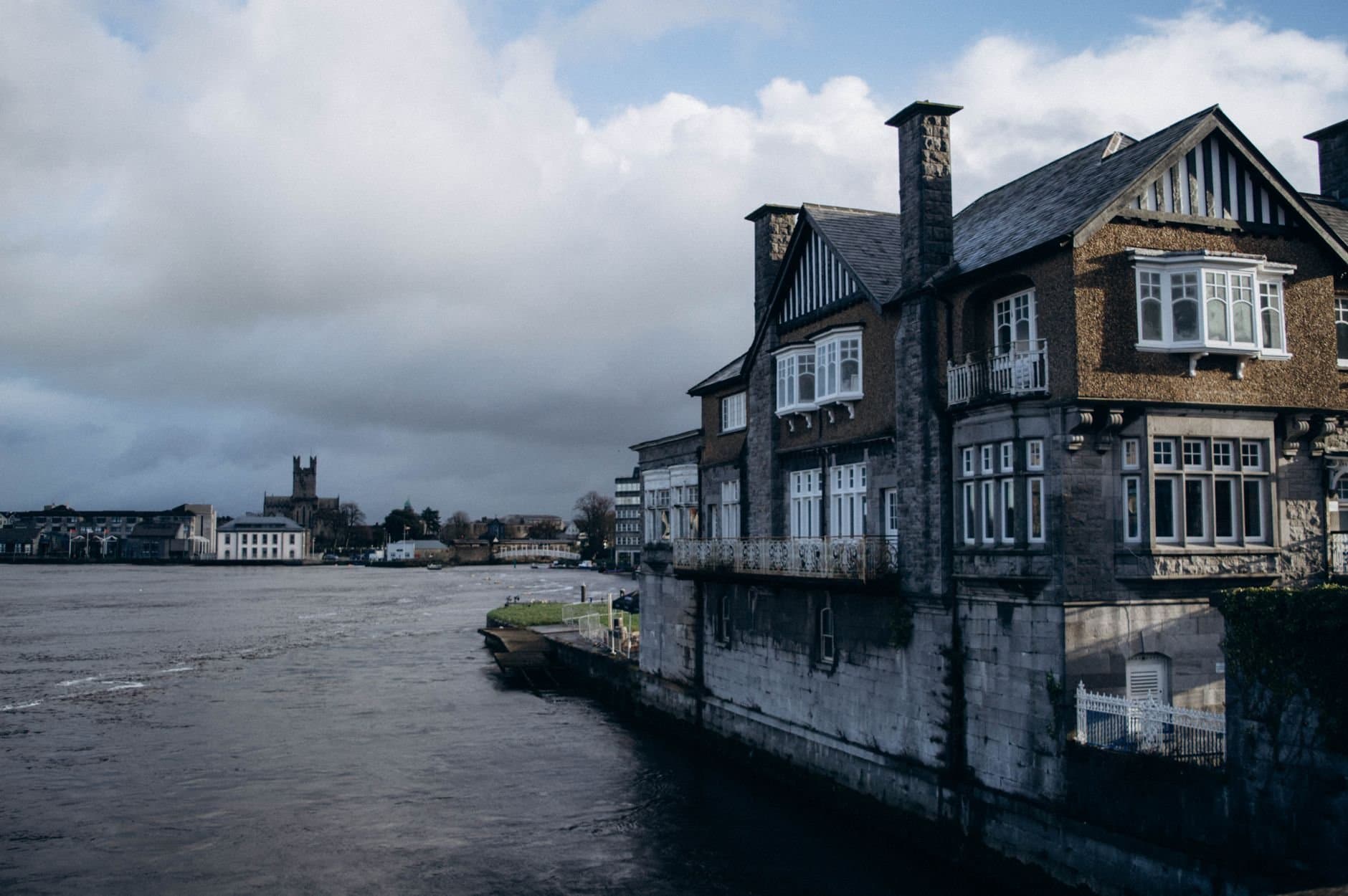 Traditional architectural houses lining the Shannon River in Limerick, Ireland.